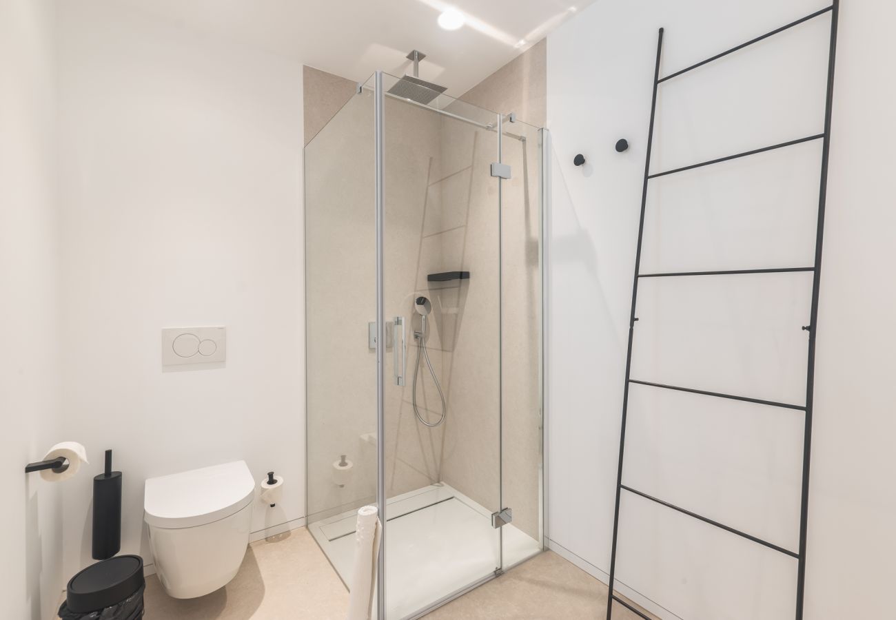 Spacious bathroom with bath and floor-level walk-in shower